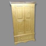 A modern pine 2-section 2-door wardrobe, with drawer under, 111 x 193 x 57cm