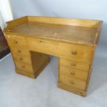 A 1930s pine kneehole writing desk with 7 fitted drawers, 122 x 86 x 60cm, kneehole 41 x 54cm