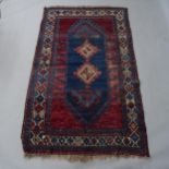 A red ground Afghan design rug, 190 x 119cm Rug has all over heavy wear with areas of loss of colour