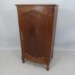 An oak Continental style music cabinet, with single panelled door and fitted interior, on cabriole