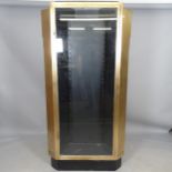 A brass and painted wooden corner shop display cabinet, with single glazed door and 3 adjustable