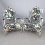A pair of mid-century French wrought-iron conservatory lounge chairs, with scrolled arms, in the