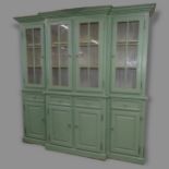 A large 2-section break-front painted pine dresser, top section having 4 glazed panelled doors,