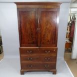 A 19th century mahogany 3-section linen press, having rail fitted interior, with 3 long drawers