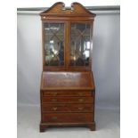 A 19th century crossbanded mahogany and satinwood-strung 2-section bureau bookcase, the fall-front