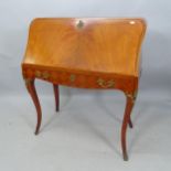 A reproduction mahogany Continental style bureau, the fall-front revealing a fitted interior, with