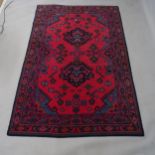 A modern red ground Persian design rug, 210 x 138cm