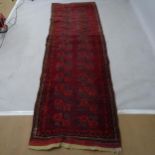 A red ground Turkish runner, 285 x 90cm There is an oval 20cm visible patch repair, other smaller