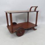 A mid-century teak trolley with solid teak wheels, with retailer's label to underside: E L Ward Ltd,