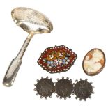 A 19th century engraved silver caddy spoon, a relief carved cameo brooch in silver mount, a micro-
