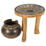 An Ashanti stool with inset beadwork decorated seat, height 29cm, and an African terracotta