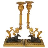 A pair of gilt-bronze candlesticks with hound figures, height 25cm