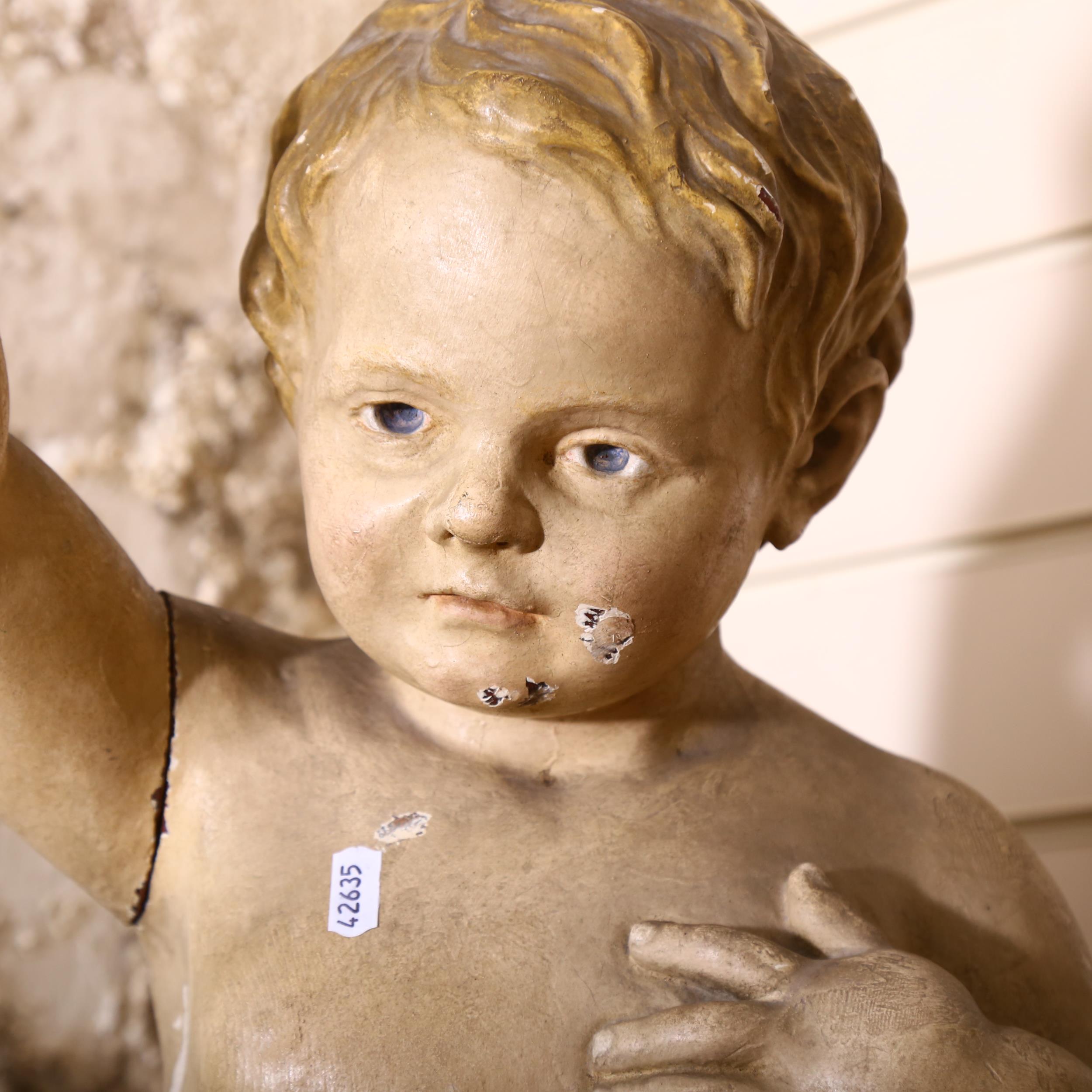 A large 19th century Continental carved wood and gesso study of a cherub holding a love apple, - Bild 2 aus 2