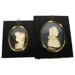 Lesley Ray, a pair of wax relief portraits in ebonised frames, largest 18cm x 15cm, with labels to