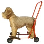 A Vintage Plush covered push-along dog, by The International Model Aircraft Ltd, with label,