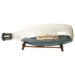 A mid-century scratch-built model of the SS Iberia presented in a tolly bottle, (this was the flag