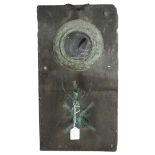 A slate-backed wall mirror with sconce, height 56cm