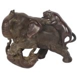 A Meiji Period Japanese cast-bronze sculpture "elephants with tigers", signed to the base, height
