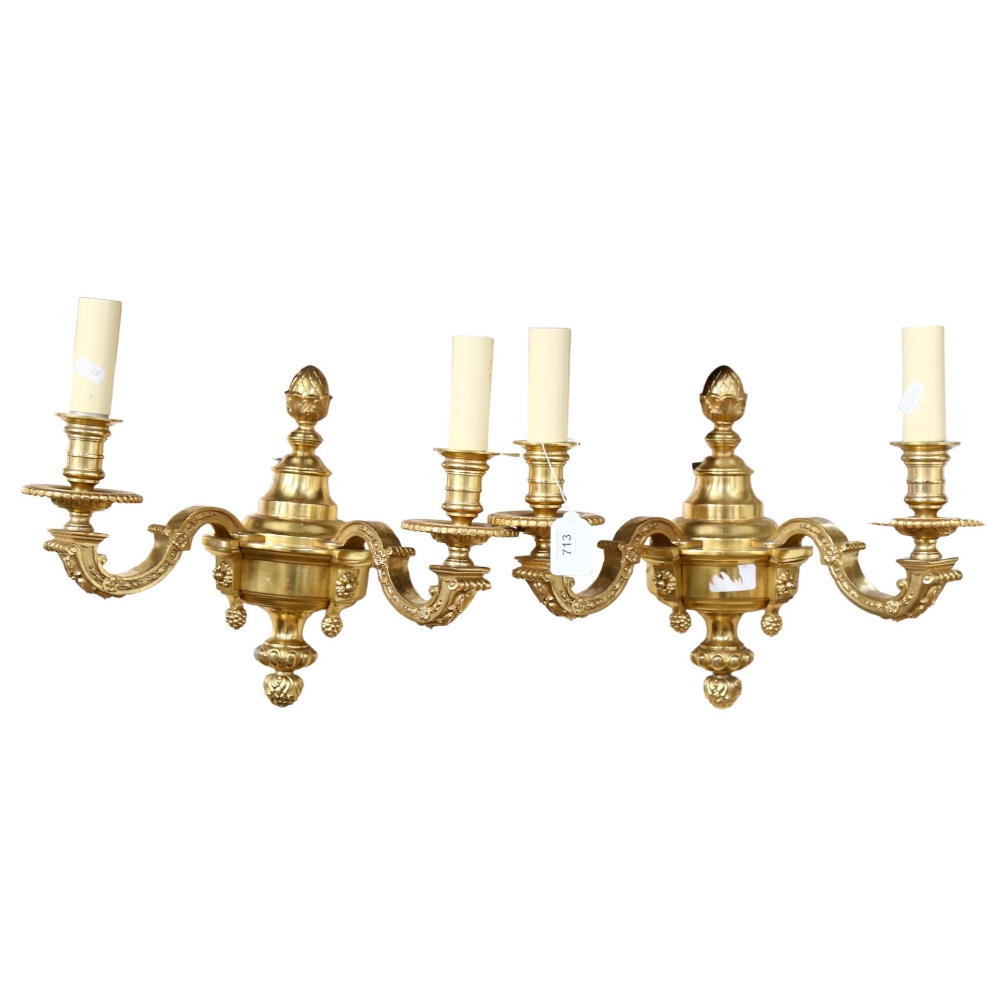 A pair of ornate gilt-brass twin-sconce wall lights, 36cm across