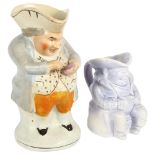 An Antique pottery Toby taking snuff, and a smaller Toby jug