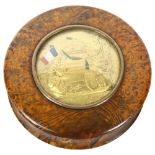 A 19th century French circular burr-walnut box, the lid having an inset medallion commemorating