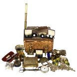 A Vintage wicker basket containing various items, including a mini brass telescope, a brass lion