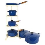 A set of blue Le Creuset pans, and accompanying stand, set includes 2 large cooking pots, a frying