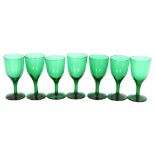 A set of 7 early 20th century Bristol green glasses, height 12cm