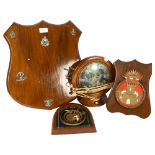 A group of wooden plaques with various Regimental/Nautical badges and crests, a maritime lamp in the