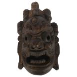 A modern wood carved African Tribal mask, length 33cm