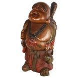 A carved and stained wood smiling Buddha, height 62cm
