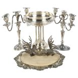 A pair of silver plated 2-branch candelabras, a bread board in plated stand, a table stand on 4-