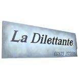 A large sign painted on panel, La Dilettante, 58cm x 172cm