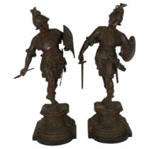 A pair of patinated spelter Middle Eastern warrior figures, on shaped plinth bases and wooden