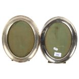 A pair of George V oval silver-fronted picture frames with easel stands