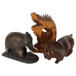 An ebony carved wood Indian elephant, with plastic tusks and eyes, a hardwood carving of a lion, and