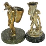 A pair of Vintage brass match strikers on onyx bases, figures depict fishermen or tradesmen, largest