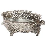 An American cast silver plate oval 2-handled table centre, with scrolled pierced foliate decoration