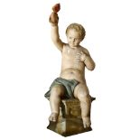 A large 19th century Continental carved wood and gesso study of a cherub holding a love apple,