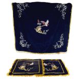 A pair of Chinese silk embroidered cushion covers and matching table cloth, on blue ground, with