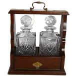 A pair of Vintage style glass decanters in a wooden tantalus, H32cm, W18cm, L29cm