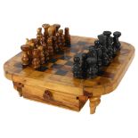 A turned olive wood chess set with fitted drawers underneath chess board, board 28cm square, King