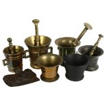 A group of brass and iron pestles and mortars, and a copper dish