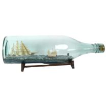 A mid-century scratch-built 4-mastered tea clipper and Chinese junk presented in a tolly bottle,