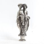 A white metal desk seal depicting Shakespearian characters (lovers). Length 8.5cm