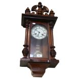 A 2-train wall clock in ornate carved frame, height 66cm