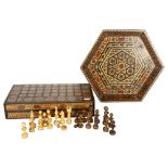 An Iranian chess set, with bone and wood inlaid decoration, in protective case, and a tray of