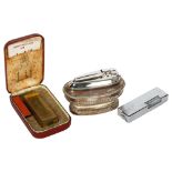 A Vintage Dunhill gold plated lighter in original case, a Ronson silver plated table lighter, and