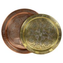 A Turkish copper and silver inlaid tray with stylised design, diameter 40cm, and a brass copper