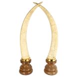 A pair of composition Scrimshaw style ornamental horns on plinths, height 76cm